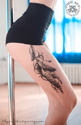Tatouage plume sur le coté de la cuisse